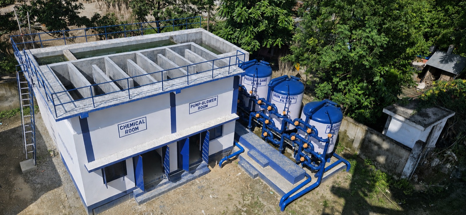 Aerial view of the Dakshin Jhitkipota treatment plant in West Bengal: pressure sand, iron removal and arsenic removal vessels beside the chemical and pump rooms.