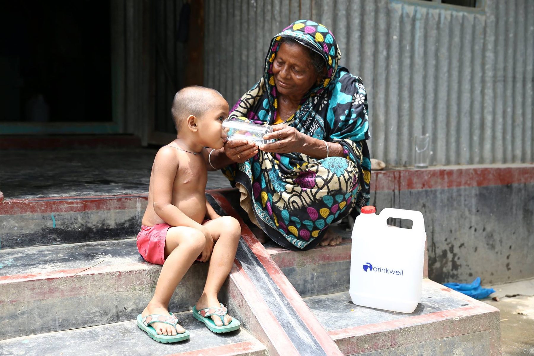 A mother and child at a Drinkwell water point.