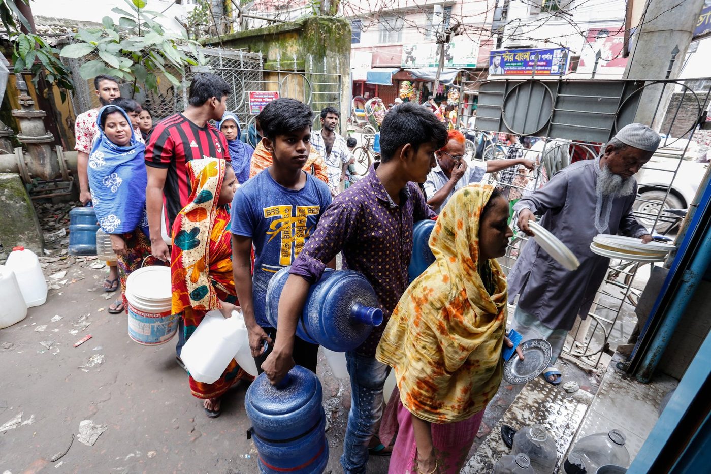 Customers with their water jugs at a Drinkwell Water ATM in Dhaka.